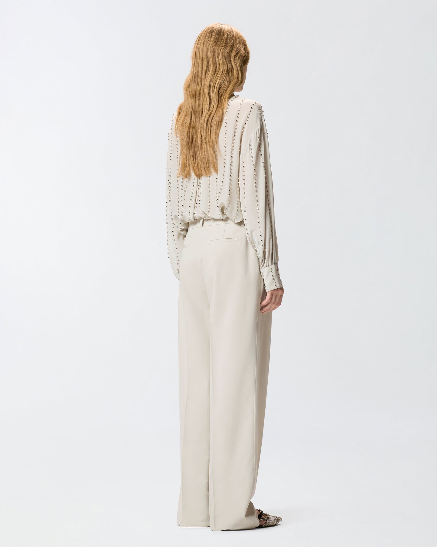Flowing trousers with pressed pleat detail